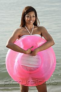 PictureIndia - woman at beach with pink tube