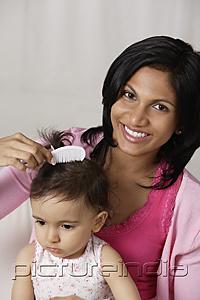PictureIndia - woman combing baby's hair
