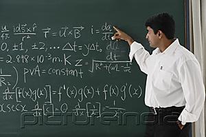 PictureIndia - teacher explaining formula at chalkboard