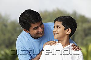 PictureIndia - Father looking at son smiling.