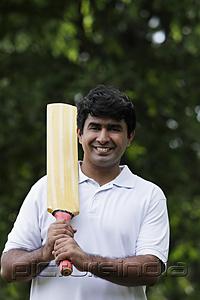 PictureIndia - Indian man holding cricket bat