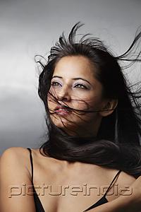 PictureIndia - head shot of woman with hair blowing around her face