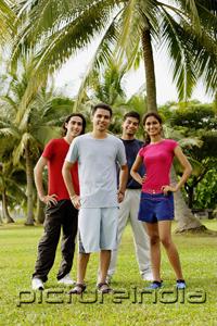 PictureIndia - Young adults standing in park, looking at camera, hands on hips