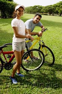 PictureIndia - Couple on bicycles, looking at camera
