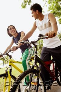PictureIndia - Two young men on bicycles, low angle view