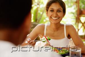 PictureIndia - Couple eating, woman holding fork and smiling at man across from her
