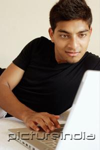 PictureIndia - Man using laptop