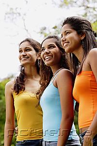 PictureIndia - Young women standing in a row, looking away