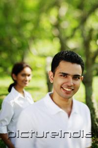 PictureIndia - Man smiling at camera, woman in the background