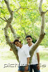 PictureIndia - Couple looking at camera, tree between them