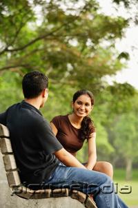 PictureIndia - Couple sitting and talking on bench