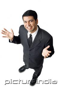 PictureIndia - Businessman, hands raised, palms facing up, looking at camera