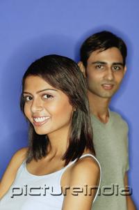 PictureIndia - Woman smiling at camera, man standing behind her