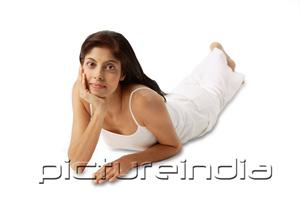 PictureIndia - Woman lying on front, hand on chin