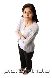 PictureIndia - Woman looking at camera, arms crossed
