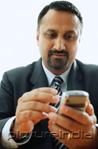 PictureIndia - Businessman using PDA phone