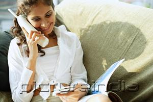 PictureIndia - Woman sitting, using cordless phone
