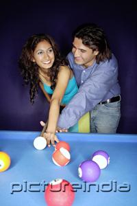 PictureIndia - Man teaching woman how to play pool