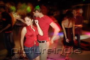PictureIndia - Young adults in night club, dancing