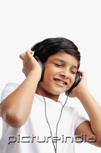PictureIndia - Boy wearing headphones, eyes closed