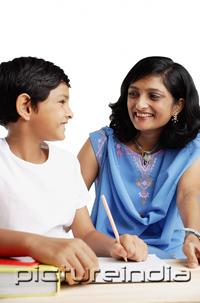PictureIndia - Son doing homework, turning to look at his mother