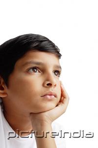 PictureIndia - Boy looking away, hand on chin