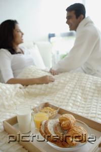 PictureIndia - Couple in bedroom, breakfast tray on the bed